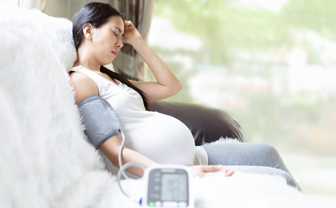 Asian pregnant woman is monitor blood pressure while she has hea